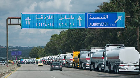 Tanker trucks carrying crude oil for export line up to enter the Mediterranean port of Baniyas, Syria, Tuesday, Sept. 29, 2026.