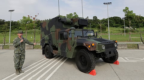 A soldier briefing a specialized HIMARS (M142 High Mobility Artillery Rocket System) command and control vehicle based on an M152A1 HMMWV during a media event in Tainan, Southern Taiwan, Tuesday, Sept. 22, 2026. 