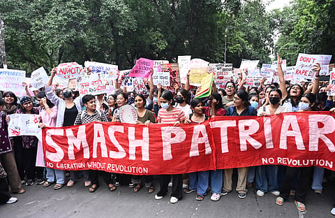 Students hold posters as they take part in the Hum Azad Hain Solidarity March from Miranda House college to Faculty of Arts college, in New Delhi.