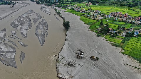 Farmland covered in mud and houses damaged by flash floods are seen along the banks of the Trishuli River in Galchi, in Nepal's Nuwakot district, Wednesday, Sept. 23, 2026. 
