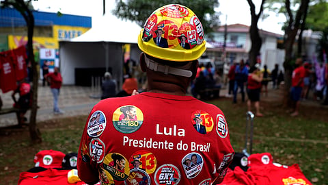 A street vendor of campaign merch promoting Brazilian President Luiz Inacio Lula da Silva, who is running for reelection, waits for customers during a campaign rally in Sao Paulo, Brazil, Saturday, Sept. 26, 2026.