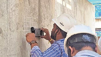 The under-construction flyover being inspected by team members.