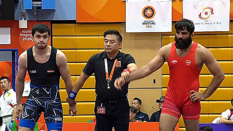 Indian Greco-Roman wrestler Sunil Kumar (R) after one of his bouts in the Asian Games on Wednesday