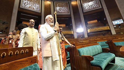 Prime Minister Narendra Modi carries the Sengol in a procession before installing it in the Lok Sabha chamber at the inauguration of the new Parliament building, in New Delhi.
