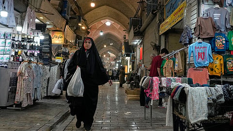 A woman walks through Tehran's traditional main bazaar, Iran, Thursday, Sept. 24, 2026.