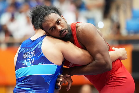 India's Nitesh Siwach (R) competes against Japan's Yuri Nakazato during the men's Greco-Roman 97kg final at the Asian Games in Nagoya, Japan on Thursday