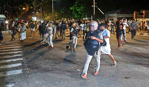 Police personnel use batons to disperse students during a clash between SFI and KSU workers near the Stone Throne at Palayam in Thiruvananthapuram. Police also used tear gas and resorted to a lathi charge near the Mens Hostel of the University of Kerala amid the confrontation.