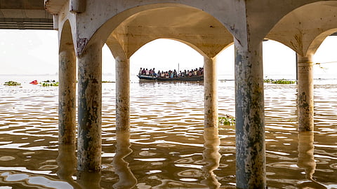 People take a boat ride as seen from the Kali Ghat, partially submerged in waters of the swollen Ganga river, in Patna, Bihar, Wednesday, Sept. 30, 2026.