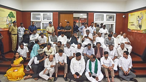 Chief Minister DK Shivakumar and his cabinet colleagues protest at the State Election Commission office in Bengaluru on Thursday.