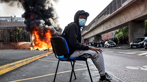 Students burn garbage as they protest to demand more resources for school in Lille, France, Thursday, Oct. 1, 2026. 