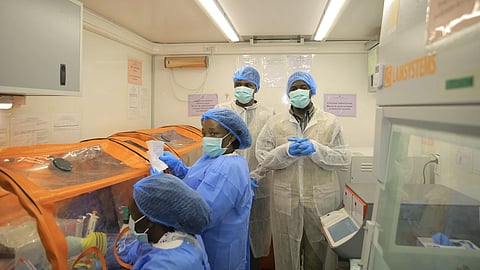 Medical workers work inside a mobile lab set up to test rapidly for Ebola virus in Butembo, Congo, Wednesday, Sept. 30, 2026.