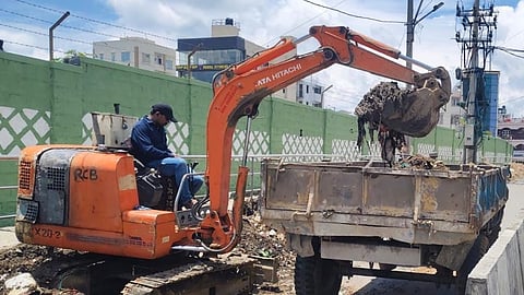 Debris being removed from a roadside in Bengaluru South City Corporation limits.