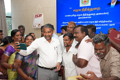 The workers clicking a selfie with the minister after expressing their gratitude for the upgraded appointment orders 
