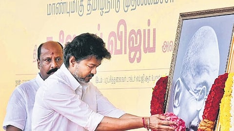 The CM paid homage at the portrait of the Mahatma ahead of launching the Vettri Payanam scheme.