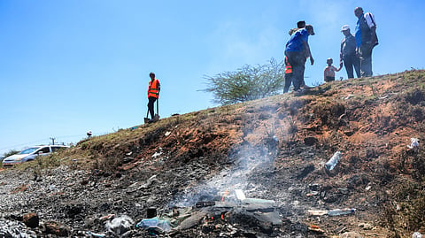 People gather at the scene where a 14-seater mini bus was involved in an accident killing all the passengers, in the Salama area, Makueni County, Eastern Kenya, Saturday, Oct. 3, 2026.