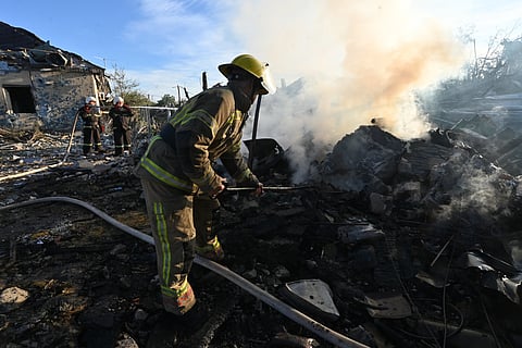 Firefighters extinguish a fire at a house following air strikes in Kharkiv on October 2, 2026, amid the Russian invasion of Ukraine.