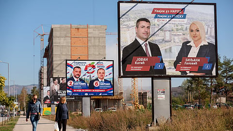 Women walk past election posters featuring Alliance of Independent Social Democrats (SNSD) and United Srpska (US) candidates for the upcoming general elections in Istocno Sarajevo, Bosnia, on Sept. 30, 2026. 