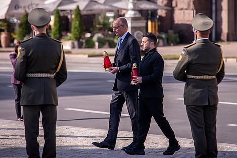 Ukraine's President Volodymyr Zelenskyy and German Chancellor Friedrich Merz attend a commemorative ceremony at the memorial of fallen Ukrainian soldiers at Independence Square in Kyiv, Ukraine, Sunday, Oct. 4, 2026. 