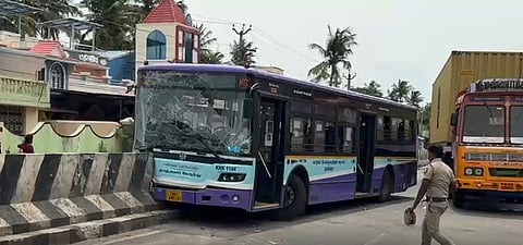Image of an MTC bus crashing into a road median.