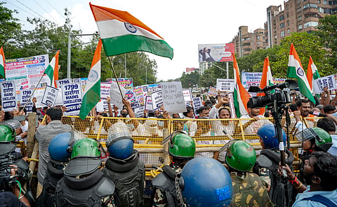  Police personnel stop aspirants during a 'Chief Minister Gherao' march against the cancellation of the Bihar Police Sub-Inspector main examination, demanding announcement of the physical test date, in Patna, Bihar, Monday, Oct. 5, 2026.
