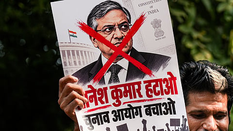  A protestor holds a poster of Chief Election Commissioner (CEC) Gyanesh Kumar during a protest by Indian Youth Congress (IYC) members against the CEC, in New Delhi, Wednesday, Sept. 23, 2026. 