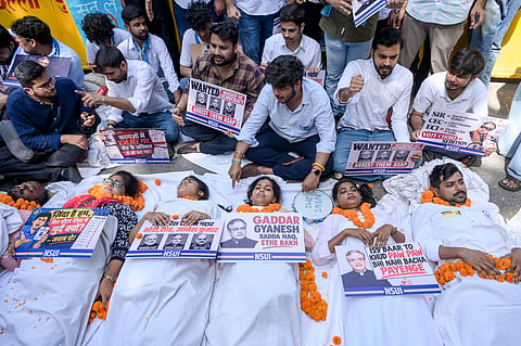 Members of National Students' Union of India (NSUI) lie on white sheets to represent dead bodies as they stage a symbolic protest demanding the resignation and arrest of Chief Election Commissioner (CEC) Gyanesh Kumar over allegations of vote chori, at NSUI headquarters on Raisina Road, in New Delhi, Monday, Oct. 5, 2026.