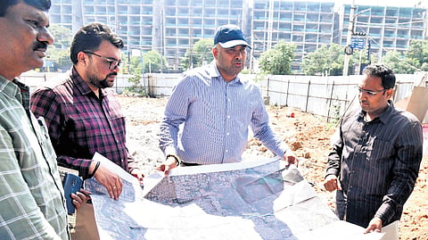 GHMC Commissioner RV Karnan, along with officials, inspects the foundation excavation works for the steel flyover project in Jubilee Hills on Monday