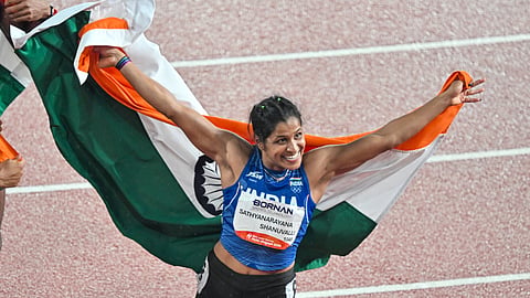 Gowda celebrates after winning the bronze medal