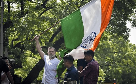  INDIA bloc leaders and supporters hold placards and wave the national flag while sitting on a dharna after being stopped by security forces during their protest march towards the Election Commission of India (ECI) office, demanding the resignation of Chief Election Commissioner Gyanesh Kumar, in New Delhi, Tuesday, Oct. 6, 2026.