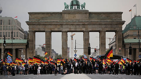AfD supporters wave AfD flags and German national flags during a demonstration in front of the Brandenburg Gate in Berlin, Germany, May 27, 2018. 