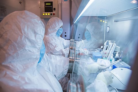 This undated photo released in 2019 by the Irkutsk Anti-Plague Research Institute of Siberia and Far East, shows the institute workers in a lab.