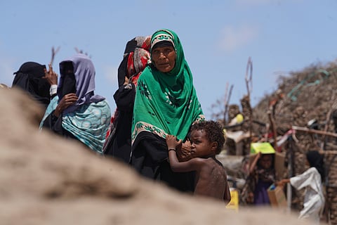 Displaced Yemeni women wait to receive aid supplies at the Al-Salam camp in Dar Saad district, Aden, Yemen, Tuesday, Oct. 6, 2026