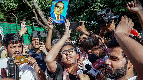 AISA President Neha Bora, along with other protesters, raises slogans during a protest near Jantar Mantar, in New Delhi on Oct.3, 2026.