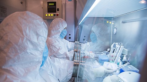 This undated file photo released in 2019 by the Irkutsk Anti-Plague Research Institute of Siberia and Far East shows the institute workers in a lab.