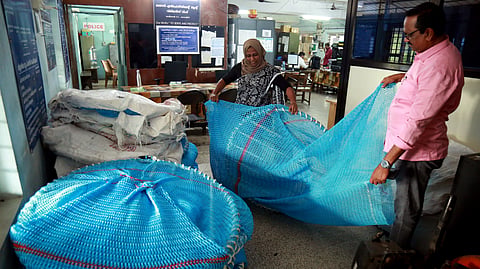 Vypin Fisheries assistant director M M Jibina explaining the functioning of Turtle Excluder Device.