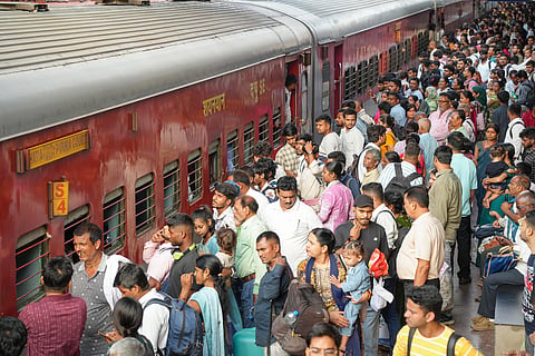 Passengers gather to board a train at Patna Junction after some Delhi-bound trains were cancelled ahead of a proposed protest by the Cockroach Janta Party (CJP), in Patna on Friday.