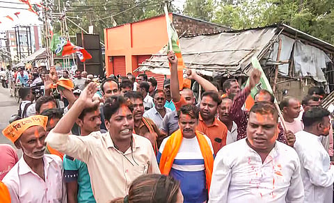 BJP workers celebrate as the party candidate Hasirani Rath (unseen) wins in the Nandigram Assembly constituency by-election, in Nandigram on Friday.