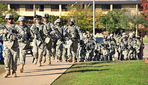 Soldiers from the 3rd Armored Cavalry Regiment storm the grounds of the Soldier Readiness Center to apprehend a mass shooter in Fort Hood, Texas, on Nov. 5, 2009.