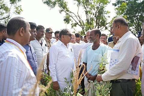 Deputy Chief Minister Dr G Parameshwara interacts with farmers during his visit to a drought-affected village in Koppal district on Thursday.