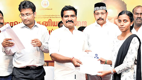 Minister C T R Nirmal Kumar handing a woman her appointment letter during a private job fair held in Madurai on Saturday.