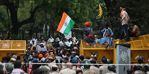 Protestors gather amidst slogans, medicare and food, under the watch of a sizeable security cordon at the Cockroach Janata Party protest in New Delhi on Thursday. 