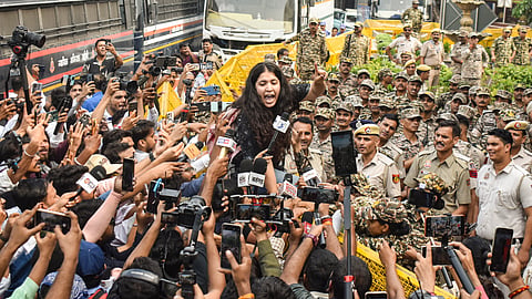 A demonstrator addresses media persons during a protest organised by the Cockroach Janta Party (CJP) demanding the resignation of Chief Election Commissioner (CEC) Gyanesh Kumar over alleged electoral roll irregularities, at Connaught Place, in New Delhi, Saturday, Oct. 10, 2026.