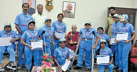Madhu Patel with her cricket team and coach Ranjit Sinh, reflecting her spirit of teamwork.
