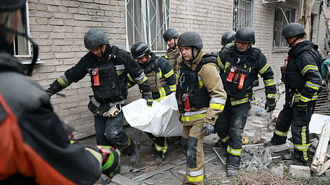 Rescue workers carry a body after pulling from the rubble of a residential building destroyed by a Russian airstrike in Zaporizhzhia, Ukraine, Saturday, Oct. 10, 2026.