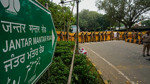 Security personnel stand guard at the barricades on a road leading to the main protest site during a demonstration demanding the resignation of Chief Election Commissioner Gyanesh Kumar in New Delhi, India, Saturday, Oct. 10, 2026 