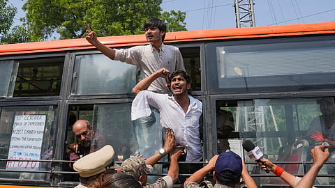 Demonstrators shout slogans from inside a police vehicle after being detained during a protest demonstration organised by the Cockroach Janta Party (CJP) demanding the resignation of Chief Election Commissioner (CEC) Gyanesh Kumar over alleged electoral roll irregularities, in New Delhi, Saturday, Oct. 10, 2026.