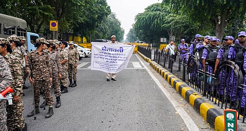 Security personnel keep vigil as heavy police deployment and entry restrictions are enforced ahead of a planned protest by Cockroach Janta Party (CJP) members, in New Delhi, Saturday, Oct. 10, 2026.