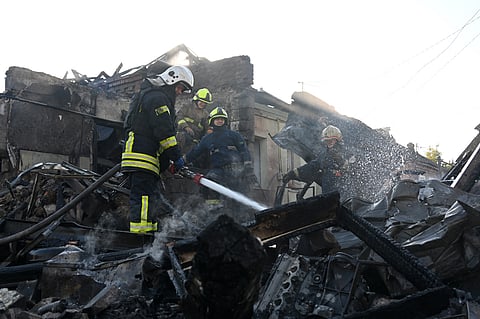 A firefighter extinguishes a fire in private houses following a Russian guided aerial bomb attack that killed one person, amid the Russian invasion of Ukraine, in Kharkiv on October 11, 2026. 