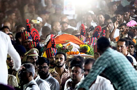 Police personnel and others carry mortal remains of veteran actor Nana Patekar during his cremation at his farmhouse at Donje village, in Pune district, late Thursday, Oct. 8, 2026