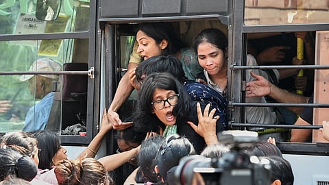 Detained protesters are forced into a bus by the police during a youth demonstration demanding the resignation of the country's election chief Gyanesh Kumar, in New Delhi, India, Saturday, Oct. 10, 2026.